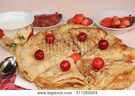 Delicious Russian Pancakes With Cherries And Strawberries And A Mug Of Milk On A Bright Table, Top V