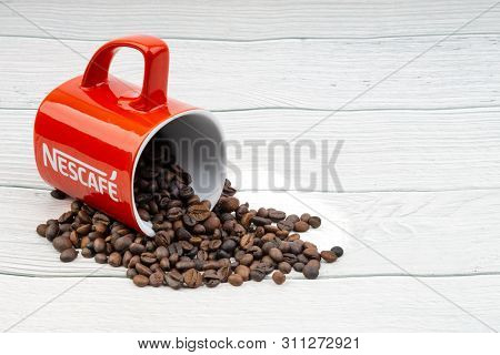 Kuala Lumpur, Malaysia - July 03, 2019: Promotional Red Nescafe Mug On Wooden Background. Selective 