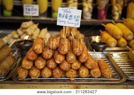 Northern Thai Spicy Sausage (sai Aua) In Multiple Languages On The Tray Ready To Eat