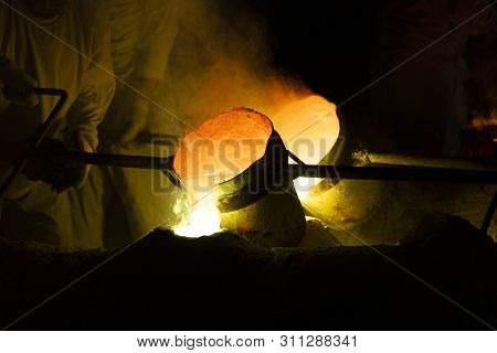 Foundry Worker Pouring Hot Molten Metal Into Mold Casting