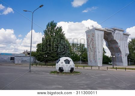 Kharkiv, Ukraine, July, 2019 Football Ball Installation And Outside Climbing Wall Near Sport Complex