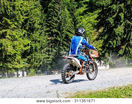 Iezer Mountains - Romania - 2019. Young Biker Having A Ride In The Forest Of Iezer Mountains On A Cr