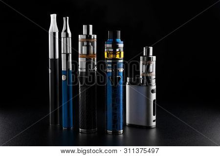 Electronic Cigarettes Or Vaping Devices On Black Background