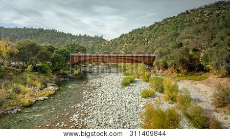 Side View Of The Bridgeport Covered Bridge At South Yuba River In California, Usa, Featuring The Fal
