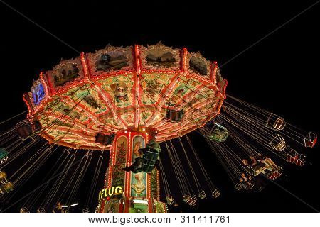 Munich, Germany - September 26, 2015: Nightshot Of The Wellenflug Carousel In Motion At Oktoberfest 