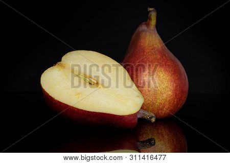 Group Of One Whole One Half Of Fresh Dark Red Pear Anjou Cross Section Isolated On Black Glass