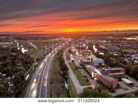 Aerial View Over Motorway A7 Entry Point On The West Side Of Groningen City Under Orange Sunset. Net