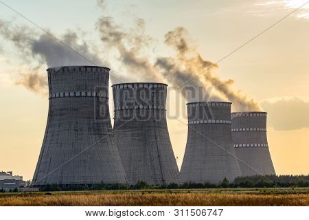 Sunset At Atomic Power Plant. View At Cooling Tower Emitting Vapor. Ukrainian Atomic Station.