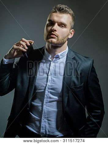 Male Smell. Man Holding Bottle Of Perfumery. Mans Perfume Concept. Elegant Man For Perfume. Masculin