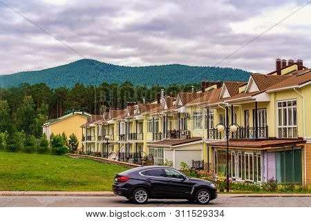 Krasnoyarsk, Russia, 14 Jule 2019: A Row Of Just Finished New Yellow Townhouses. Residential Village