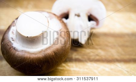 Champignons On A Cutting Board In Kittchen