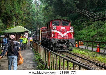 Alishan,taiwan-october 14,2018:red Train Stop In Foggy Day At Alishan Train Station On Alishan Mount
