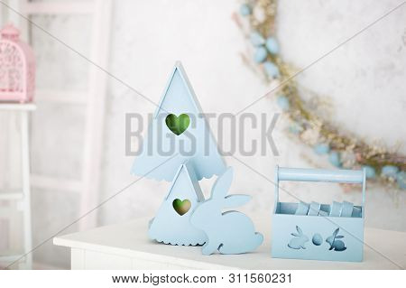 Stylish Home Decor In Blue Is A Wooden Basket, Decorative Nesting Boxes And A Cute Rabbit. Easter De