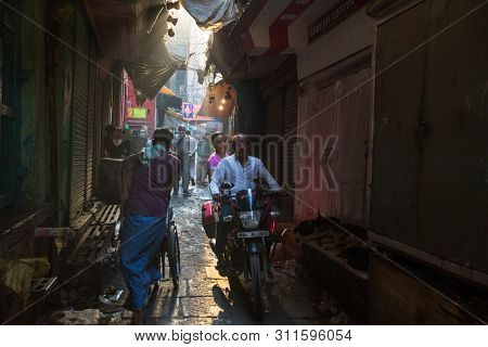 VARANASI, INDIA - MAR 22, 2018: On one of the streets of the old city near holy Ganges river. According to legends, the city was founded by God Shiva about 5000 years ago.