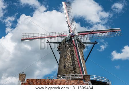 Sluis, The Netherlands -  June 16, 2019: The Iconic Brick-stone Windmill, Named Molen Van Sluis, And