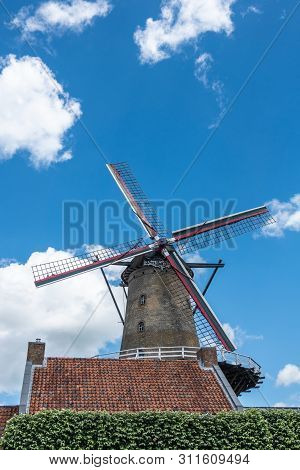 Sluis, The Netherlands -  June 16, 2019: The Iconic Brick-stone Windmill, Named Molen Van Sluis, And