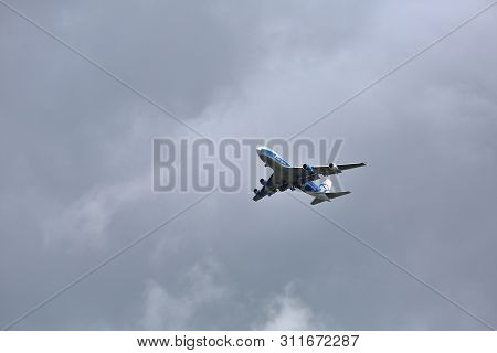 Cargo Aircraft In The Gray Cloudy Sky