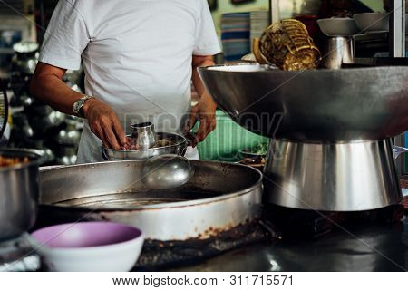Chef Cooking A Noodle Soup At Street Food Market