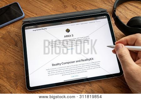 Paris, France - Jun 6, 2019: Man Reading On Apple Ipad Pro Tablet About Latest Announcement Of At Ap