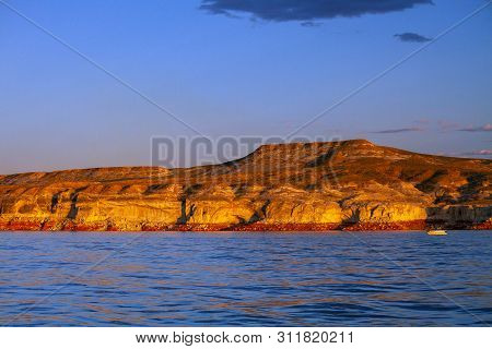 Golden Late Afternoon Light On A Desert Hill In Wahweap Bay Of Lake Powell, Arizona.  An Unmarked Bo