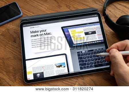 Paris, France - Jun 6, 2019: Man Reading On Apple Ipad Pro Tablet About Latest Announcement Of At Ap