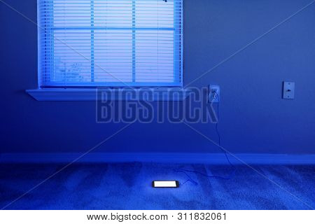 charging cellphone pluged in wall outlet in domestic house empty living room