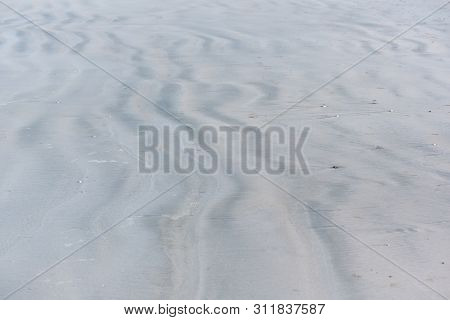 Background Pattern Of Light And Sahdow On The Sand At The Beach.