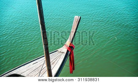 Photos Of The Bow Ship Head With Red Cloth Tied. View From Head Of Traditional Wooden Boat With Red 
