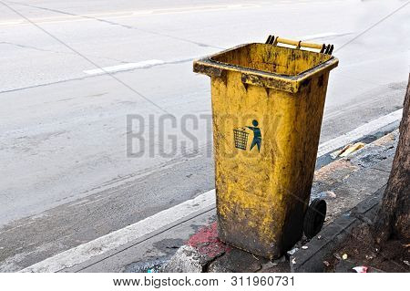 The Dirty Yellow Bin At The Street