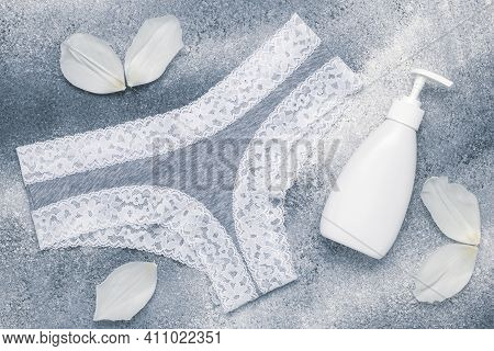Breathable Cotton Panties For Women. Liquid Soap Bottle And White Petals On A Gray Background. Sexy 