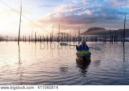 Adventurous Girl Kayaking On An Infatable Kayak In A Beautiful Lake. Colorful Peaceful Sunrise Art R