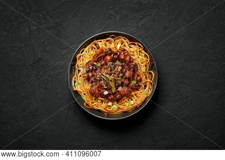 Bakmi Or Mie Ayam In Black Bowl On Dark Slate Table Top. Indonesian Cuisine Noodles Meat Dish. Tradi