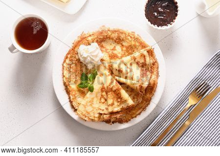 Russian Traditional Breakfast For Shrovetide Of Thin Pancakes Or Blini With Cholate And Tea On White
