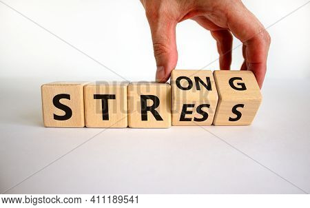 Strong Stress Symbol. Businessman Turns Wooden Cubes With Words 'strong Stress'. Beautiful White Bac
