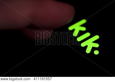 Madrid, Spain- March 3, 2021: Finger Pressing Kik App Icon On Black Screen In A Smartphone