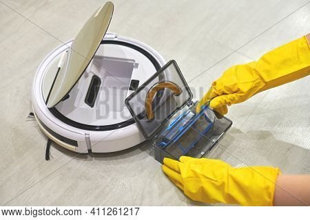 Dust Storage Box Case Of Robotic Vacuum Cleaner In Gloved Female Hands. Woman In Protective Gloves T