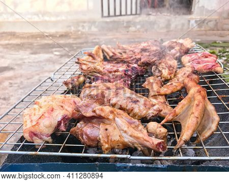 Duck Meat That Has Been Split Into Pieces Then Being Marinated With Sauce And Are Roasting On The St