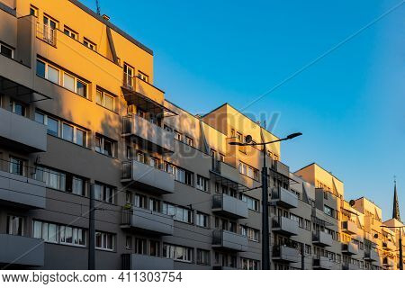 Long Block Of Flats With Balconies Highlighted By Sunset