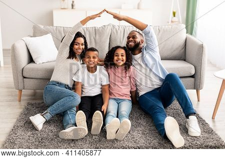 Family Care, Protection And Insurance Concept. Portrait Of Smiling African American Parents Making S