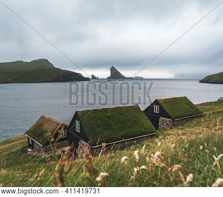 Bour Village Grass-covered Picturesque Houses At The Faroese Coastline In The Village Bour With View