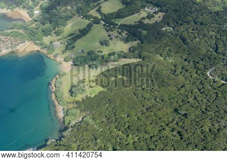Aerial Image Of Bush Clad Landscape And Coastal Bay Area Of Great Barrier Island In Hauraki Gulf, Ne