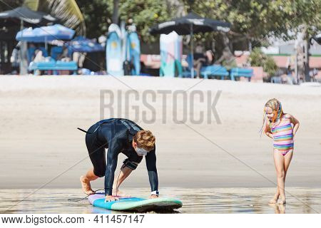 Little Surf Girl - Young Surfer Learn To Ride On Surfboard With Instructor At Surfing School. Active