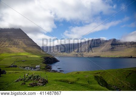 Faroe Islands. Village, Catholic Church And Green Grass.