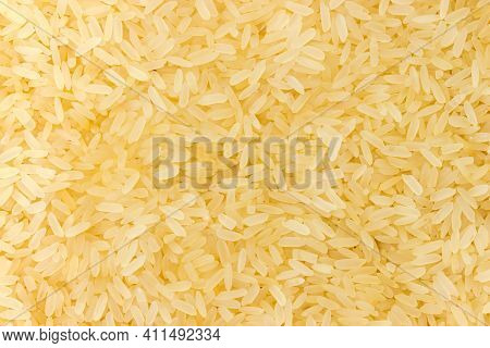 Raw Medium-grained Parboiled Rice Strewn Up Evenly, Top View Close-up, Background