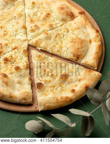 Piece Of Cheese Pizza On Green Background. Traditional Italian Food, Close Up Shot. Nutrition Dinner