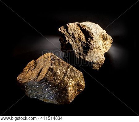 A Couple Of Shiny Muscovite Mica Mineral Crystals Isolated On Black. Found In Ural, Russia. For Geol