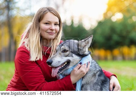 Young Happy Woman Hugging Dog. Pet Adoption.  Czechoslovak With Female Owner. Caucasian Girl Walking