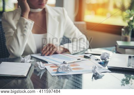 Young Businesswoman Stressed Jobs,headaches About The Job On Table,wearing White Suit (focus At Crum