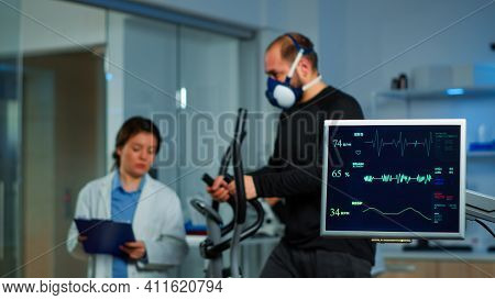 Team Of Medial Researchers Monitoring Vo2 Of Man Performance Sports Wearing Mask Running. Lab Scienc