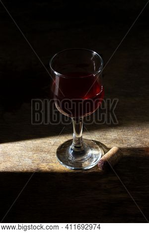 Glass Of Red Homemade Wine On A Wooden Surface. Glass Of Red Wine On A Dark Background. Alcoholic Be